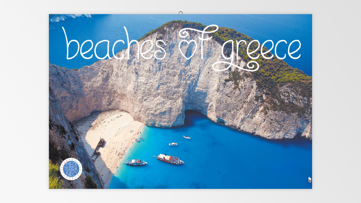 Aerial view of Greek beach with cliffs and boats.