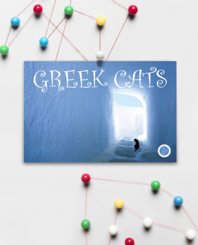 Photo of a "Greek Cats" postcard with pins and strings.