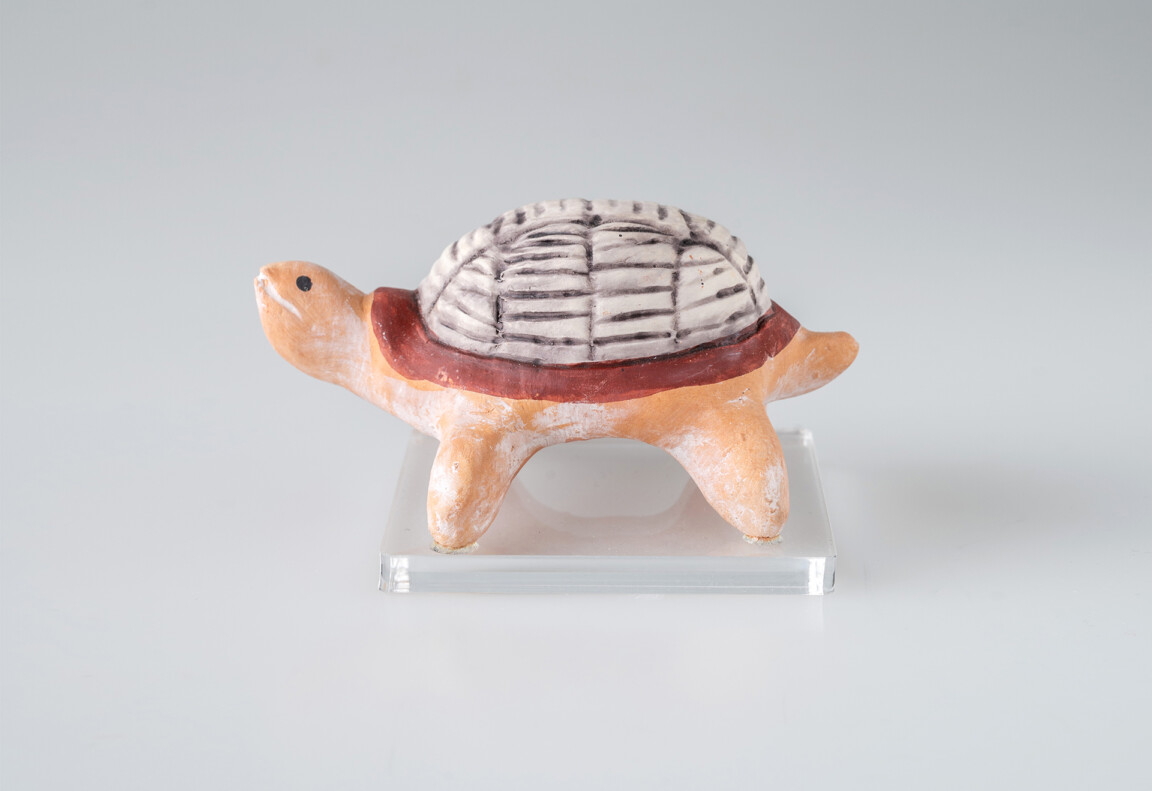Ceramic turtle figurine on white background.