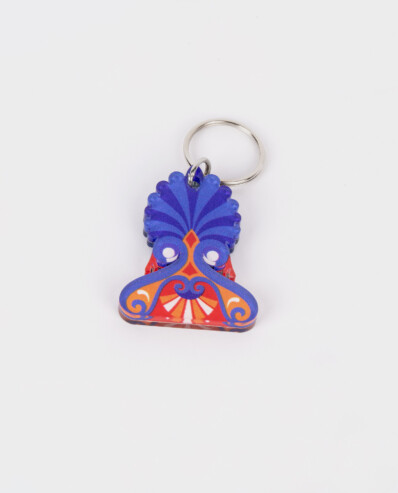 Colorful peacock keychain on white background.