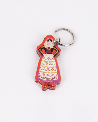 Traditional dress keychain on white background.