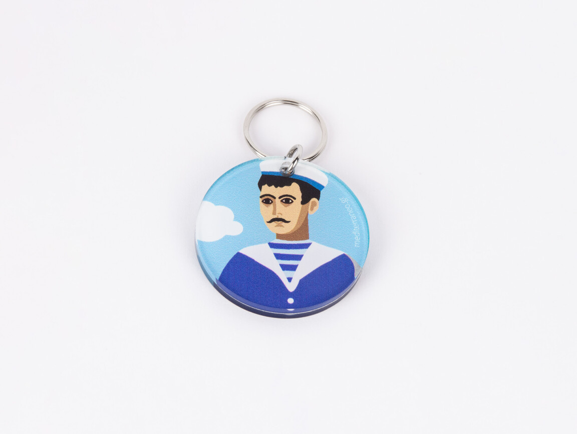Illustrated keychain with stylized male portrait and clouds.