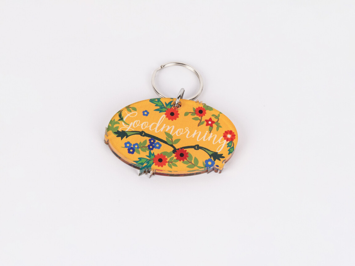 Floral "Goodmorning" keychain on white background.