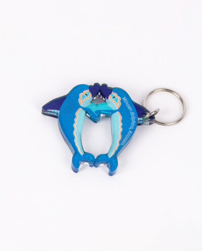 Blue dolphin-shaped keychain on white background.