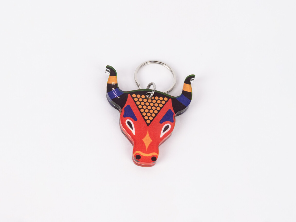Colorful bull keychain on white background.