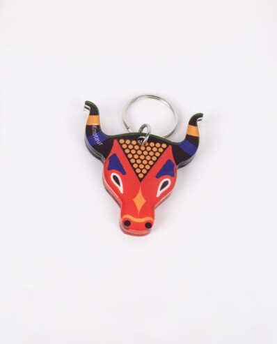 Colorful bull-shaped keychain on white background.