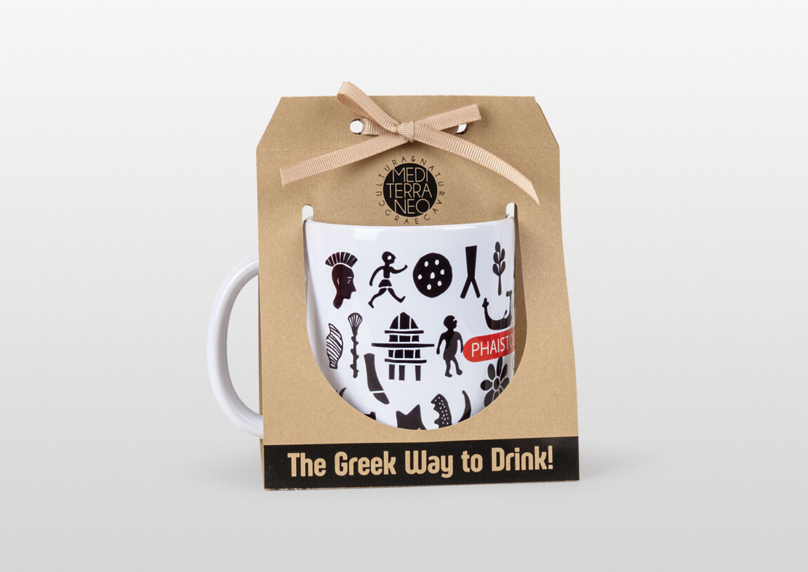 Greek-themed white coffee mug on cardboard packaging.